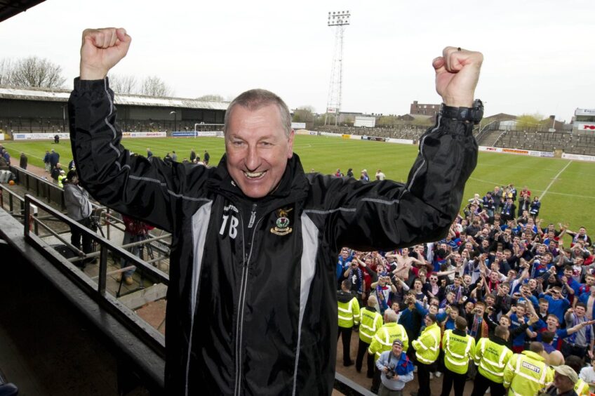 Inverness Caledonian Thistle manager Terry Butcher celebrates in front of the supporters after his team clinched the Irn-Bru First Division title after a 7-0 win at Ayr United's Somerset Park on April 24, 2010. 