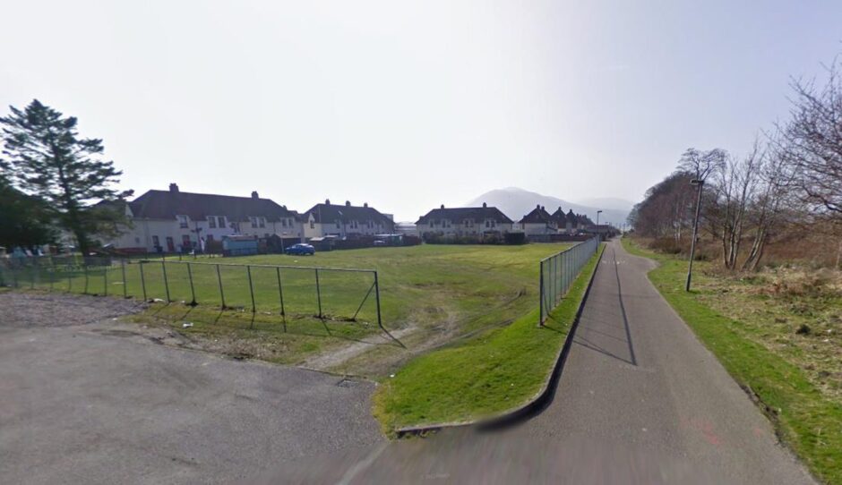 Vacant plot of land behind houses in Coal.