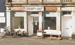 Grumpy Chef brown sign outside white building.