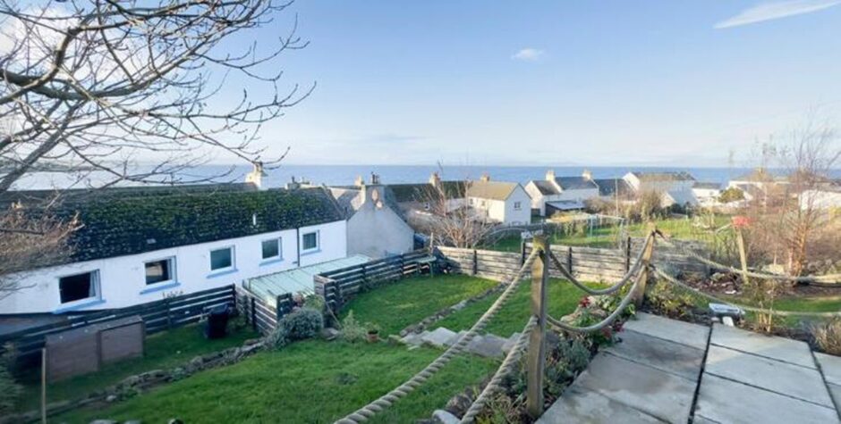 Elevated vews of the Dornoch Firth overlooking a row of homes.