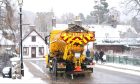 A gritter drives through Braemar. Image: Jane Barlow/PA Wire