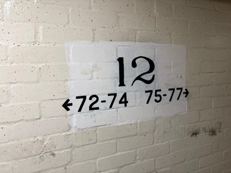 The 12th landing of the fire hit high-rise, where numbers on the wall point to some of the homes affected.