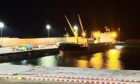 The MV Lowlands Diamond moored at Aberdeen's South Harbour, emergency services to the left.