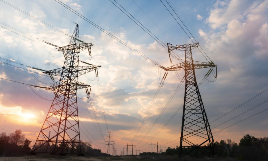 Power lines with the sunset in the background.