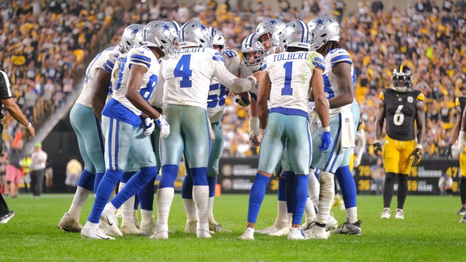 Dak Prescott in conversation with his Dallas Cowboys team-mates during an NFL match against the Pittsburgh Steelers.