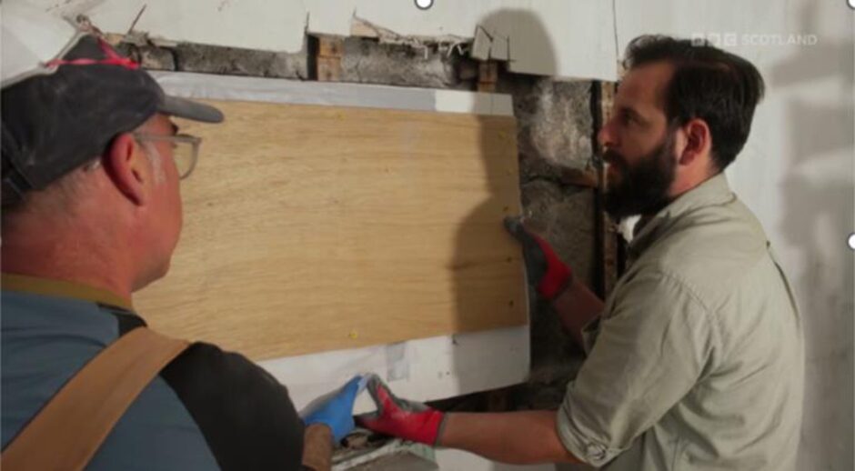 Dom and Richard retrieving the flower painting from the wall