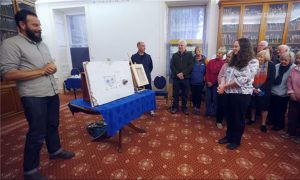 museum curator Annie MacDonald and volunteers delighted to see the restored paintings