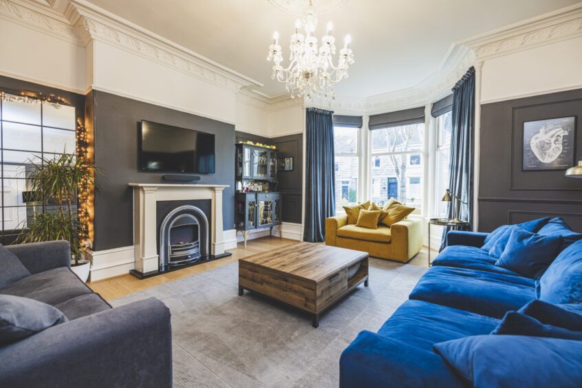 the living room with yellow and blue furnishings