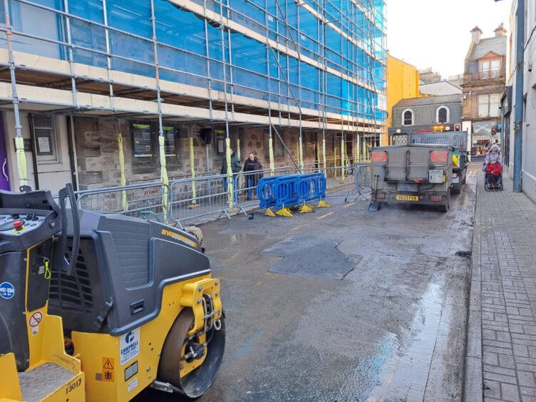 Picture showing a lorry and a newly paved section of an Inverness street.