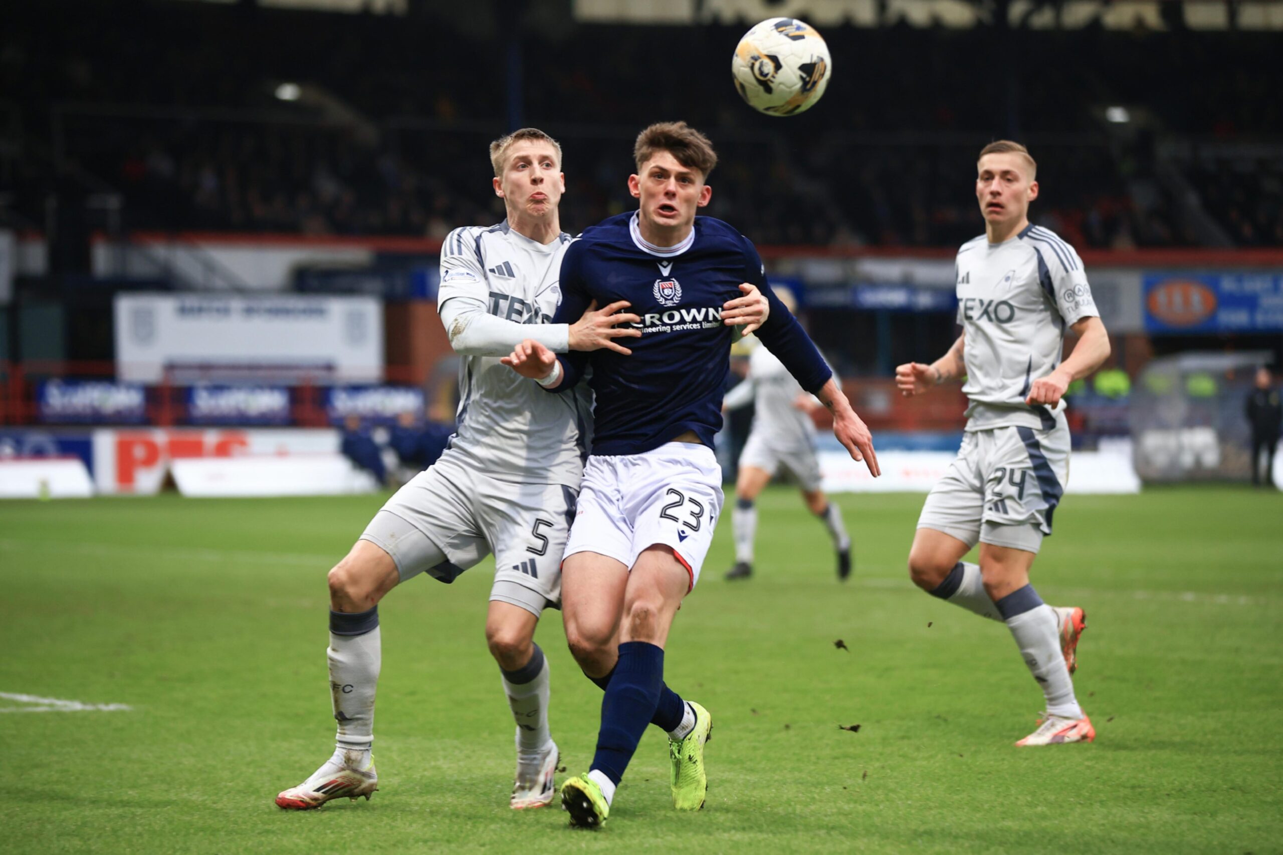 Seb Palmer-Houlden of Dundee challenges for the ball with Mats Knoester of Aberdeen in a Premiership match at Dens Park. Image: Shutterstock