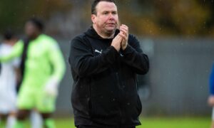 Caley Thistle head coach Scott Kellacher applauds the fans after a game against Dumbarton.