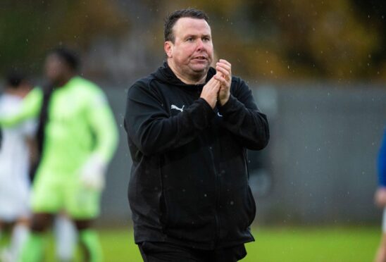 Caley Thistle head coach Scott Kellacher applauds the fans after a game against Dumbarton.