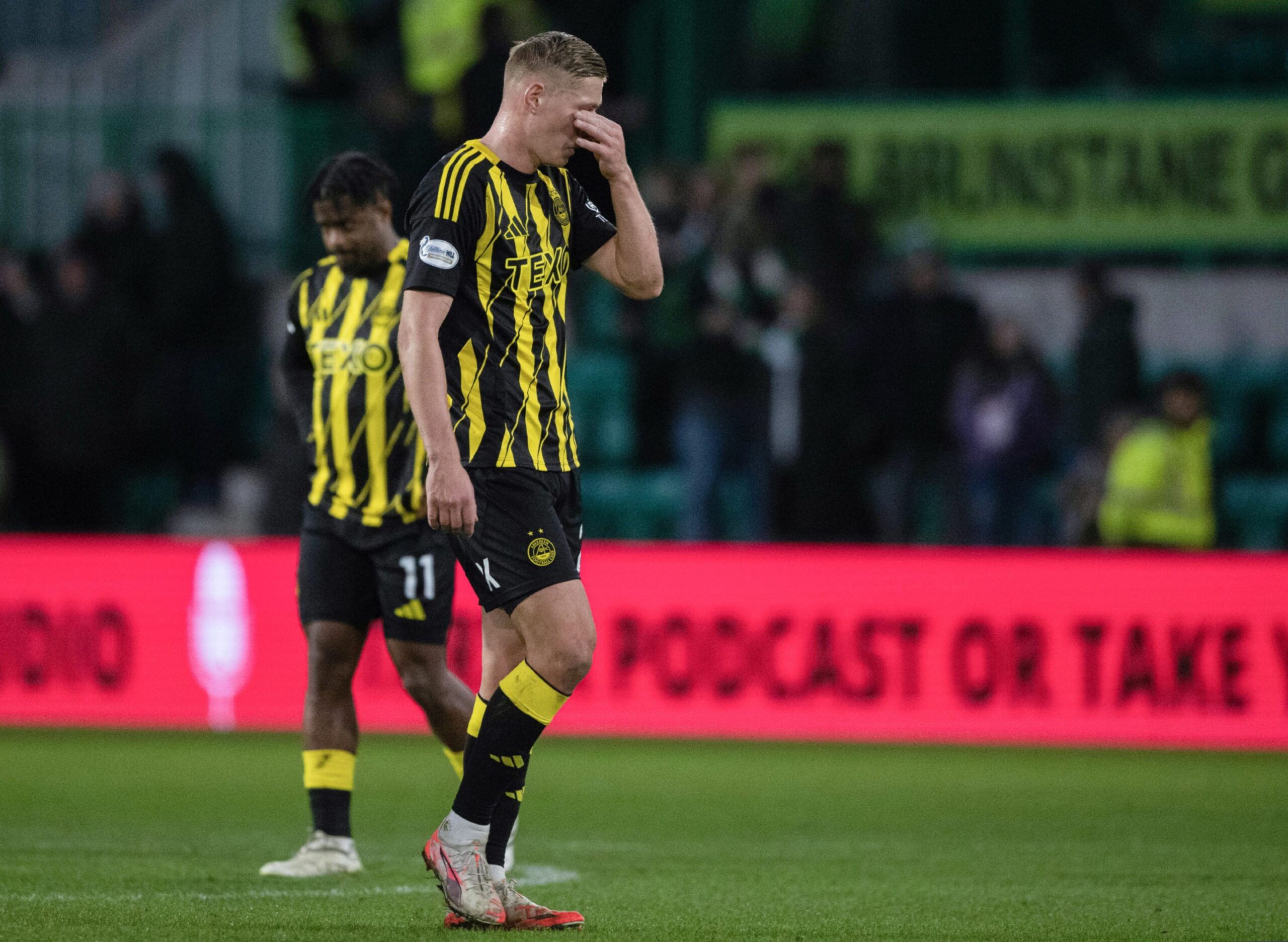 Aberdeen's Kristers Tobers looks dejected at full-time after the 2-0 loss to Hibs. Image: SNS 