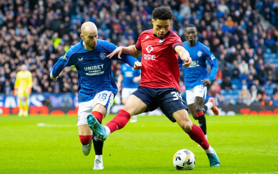 Ross County winger George Robesten running with the ball against Rangers.