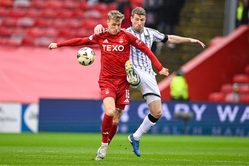 Aberdeen's Jeppe Okkels  and Dunfermline's David Wotherspoon in action during the Scottish Cup tie at Pittodrie. Image: SNS