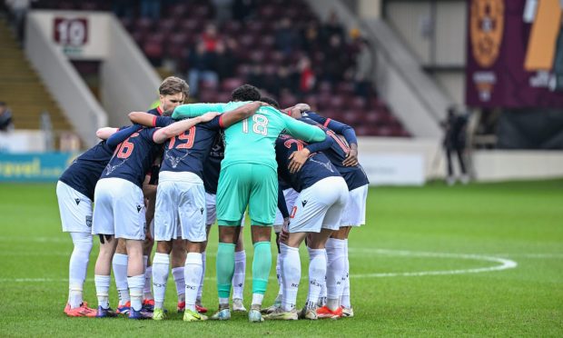 Ross County's players take part in a pre-match huddle before the game against Motherwell.