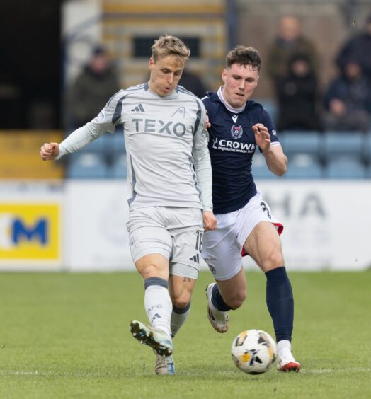 Aberdeen's Jeppe Okkels and Dundee's Josh Mulligan in action. Image: SNS