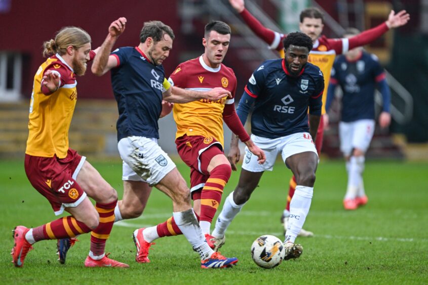 A midfield tussle between Ross County's Connor Randall, second from left, and Motherwell's Lennon Miller during Ross County's 3-0 SPFL Premiership win at Fir Park Stadium on February 15, 2025. 