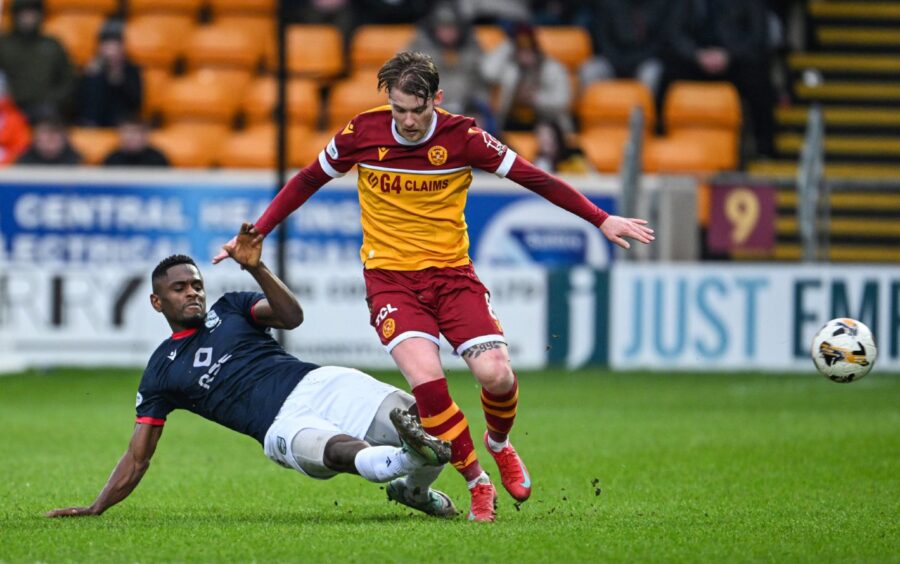 Ross County defender Akil Wright makes a tackle on Motherwell player Callum Slattery.