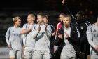 The Aberdeen players celebrate at full time at Dens Park. Image: SNS.