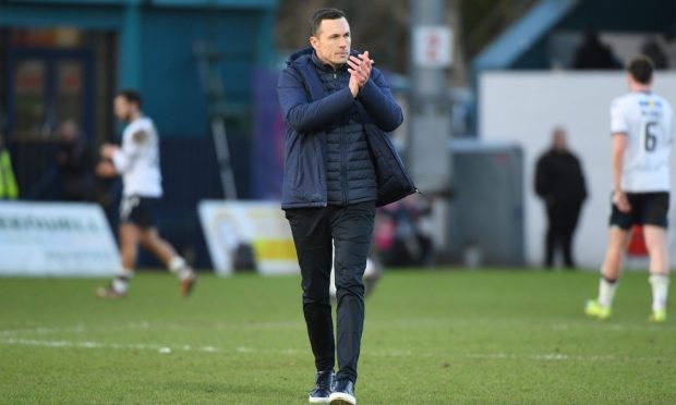 Don Cowie applauds Ross County's supporters following the win over Dundee.