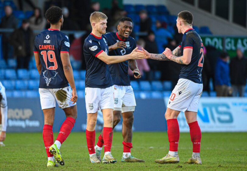 Kieran Phillips shakes the hand of team-mate Kacper Lopata after scoring for Ross County against Dundee.