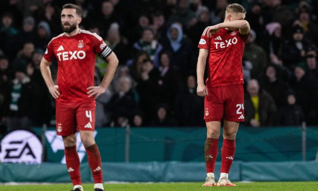 Aberdeen's Graeme Shinnie and Kristers Tobers were left dejected following the Dons' defeat by Celtic. Image: SNS