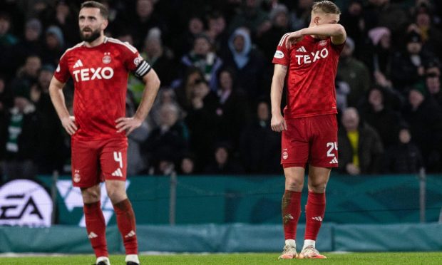 Aberdeen's Graeme Shinnie (left) and Kristers Tobers were left dejected following the Dons' defeat by Celtic. Image: SNS