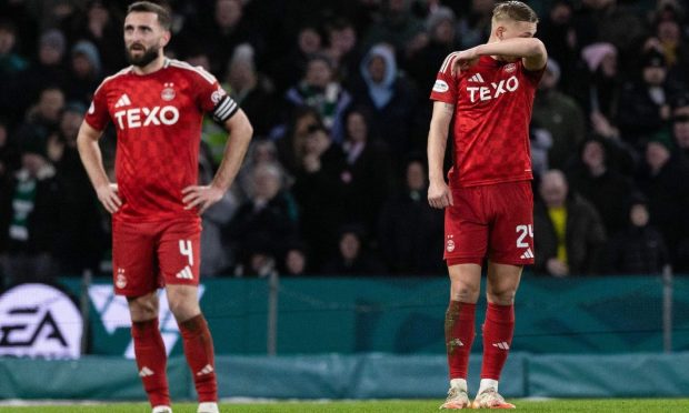 Aberdeen's Graeme Shinnie (left) and Kristers Tobers were left dejected following the Dons' defeat by Celtic. Image: SNS