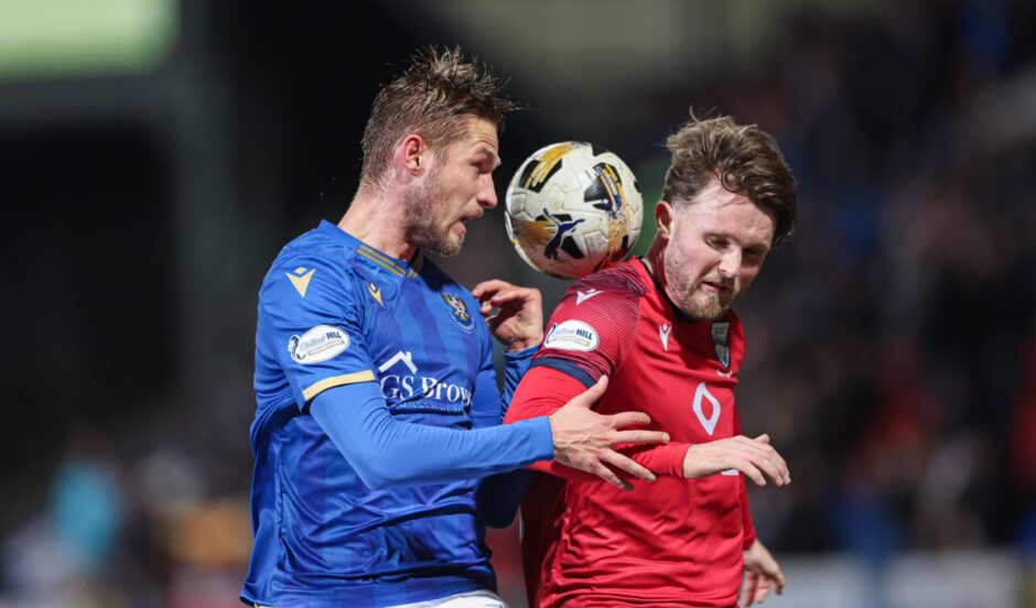 Noah Chilvers takes on St Johnstone's Daniels Balodis. 