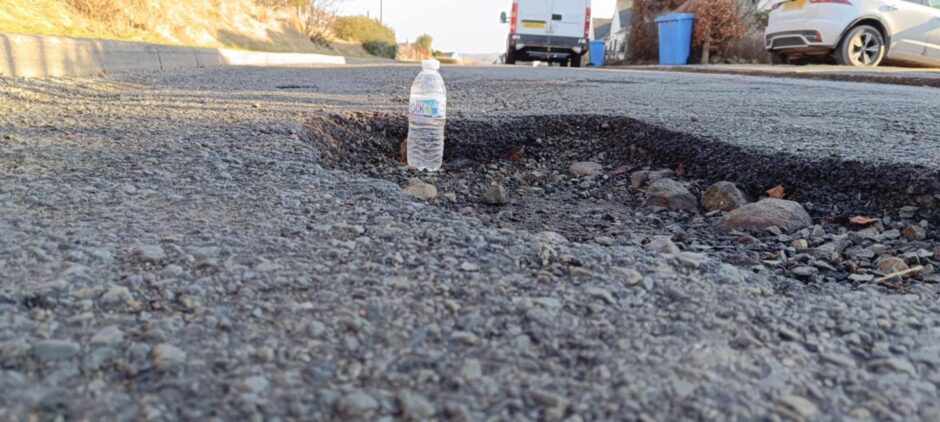 Potholes in Portree on Skye with a bottle in it. 