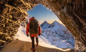 Adrian Trendall in the Cullin Mountain range in Skye, at the mouth of the Sgùrr Sgumain bivy cave.