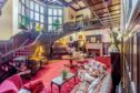 The stunning period reception hall. Feature staircases swirl up to the first floor.