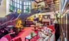 The stunning period reception hall. Feature staircases swirl up to the first floor.