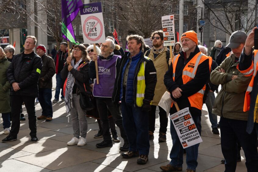 Crowd gathered at protest against fire and rehire 