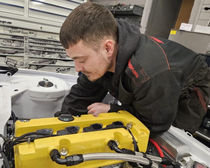 Owner Bob Barron working on an engine. Image: Barron Automotive