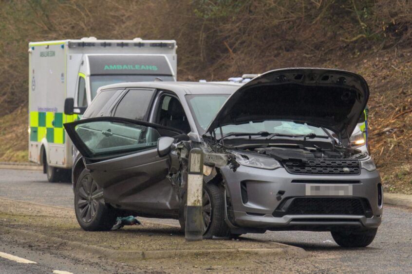 Ambulance behind grey car with bonnet open following crash.