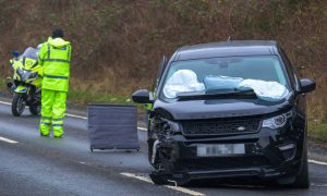 Black vehicle with air bags deployed following crash.