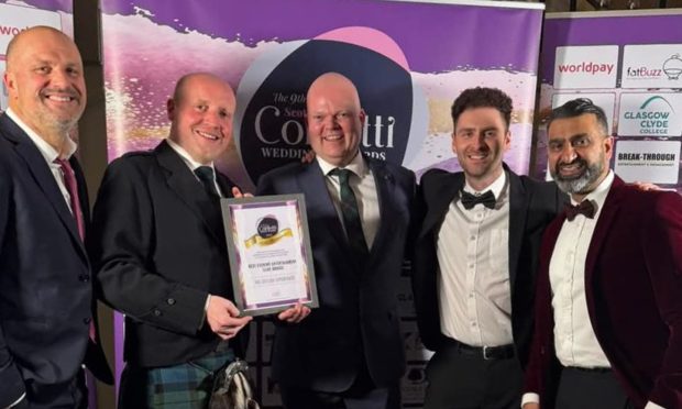 The five male members of The Ceilidh Experience band holding their certificate.