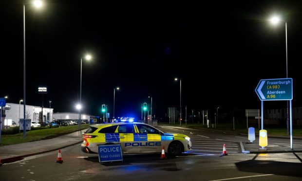 Police car at Elgin in the dark, following the incident.