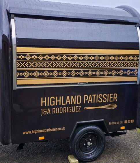 Picture of Highland Patissier new mobile shop, which is painted black and decorated with gold writing.