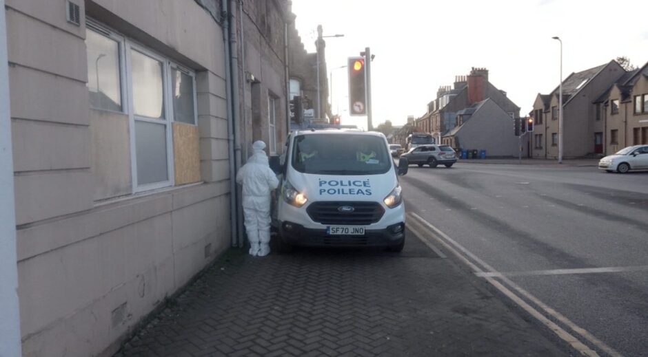 Forensic officers next to police van on Tomnahurich Street in Inverness