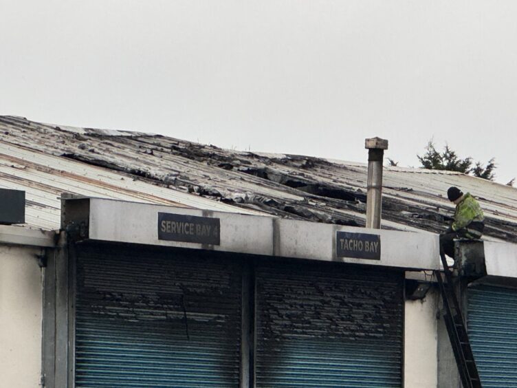 Picture showing fire damage to roof and shutter of industrial premises. 