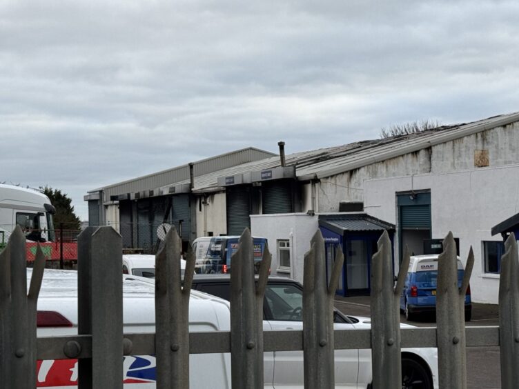 Image showing metal fence and fire damaged business.