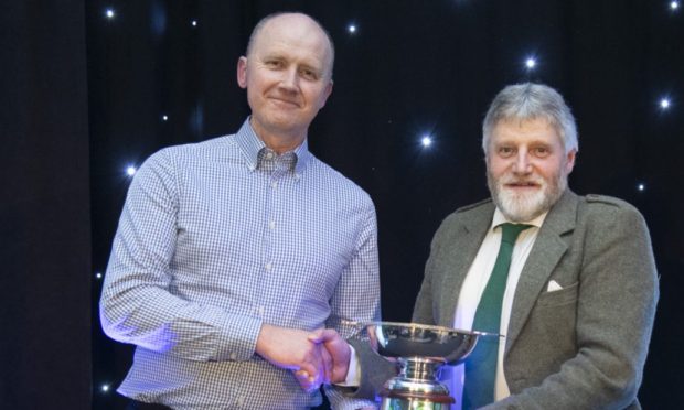 Euan Warnock receives the Miskelly award from former NFU Scotland president Martin Kennedy