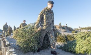 RAF Lossiemouth serviceman pulling Christmas tree