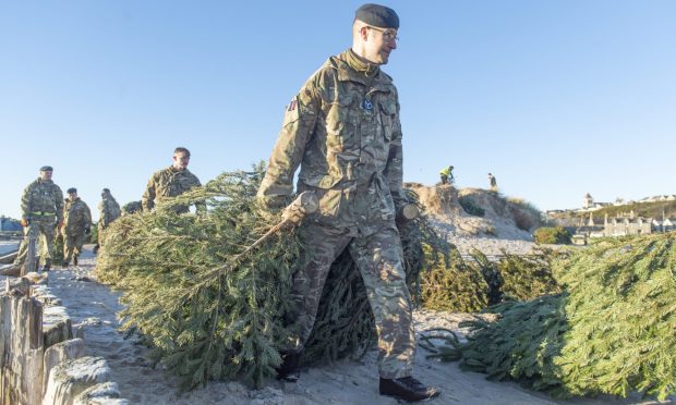 RAF Lossiemouth serviceman pulling Christmas tree