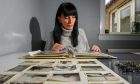 Katrine Duncan with her dad's mementos from his days in the merchant navy and as an officer at Peterhead Prison. Image: Kenny Elrick/DC Thomson