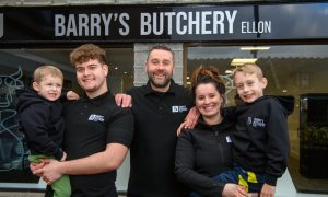 Noah, 3, Kai, 18, Barry, Marie-Ann, and Olly, 7, outside Barry's Butchery