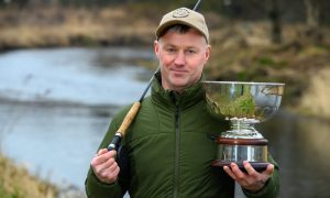 Steven Corsar with the Scottish National Fly Fishing League trophy by the River Don. Photos by Kenny Elrick/DC Thomson.